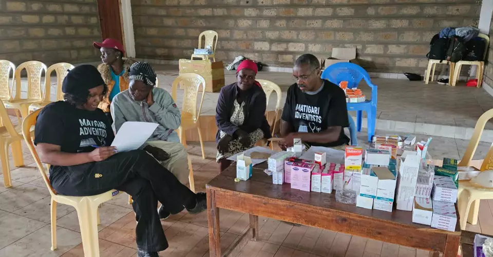Volunteers preparing medicine at a health camp